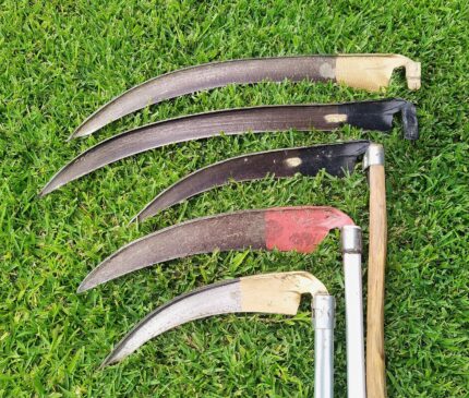 A range of scythe blades and snaths